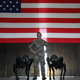 U.S. Air Force Tech Sgt. Brandon Priddy, 45th Security Forces Squadron non-commissioned officer in charge of innovation and technology poses for a picture with Ghost Robotics Vision 60 Quadruped Unmanned Ground Vehicles (Q-UGV) at Cape Canaveral Space Force Station, Fla., July 28, 2022.